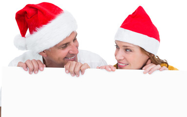 Festive couple showing a poster