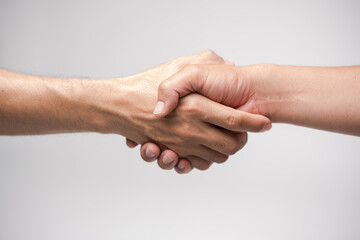 Close up two man shaking hand on white background.Athletes shaking hands before sports competition. Unity and teamwork concept.