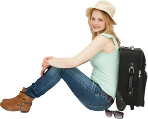 Portrait of smiling woman sitting by luggage