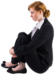 Unhappy redhead businesswoman sitting