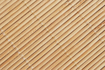 Light brown asian bamboo reed mat texture as background
