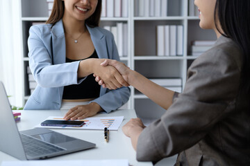 Fototapeta premium Successful team of businesswomen shaking hands after finished the business deal.