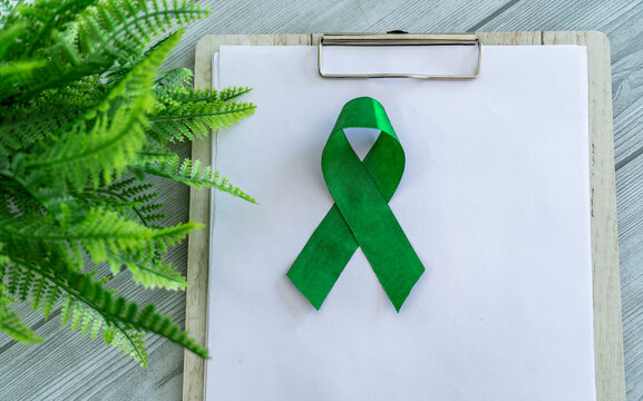 Spinal Cord Injury Awareness Day concept image, Green ribbon with copy space, World Glaucoma Day background