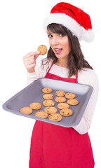 Brunette in santa hat showing hot cookies