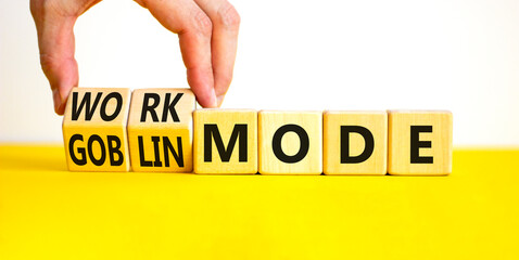 Work or goblin mode symbol. Concept word Work mode Goblin mode on wooden cubes. Businessman hand....