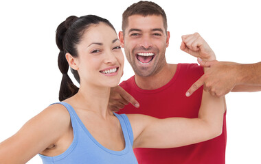 Fit woman and trainer smiling at camera