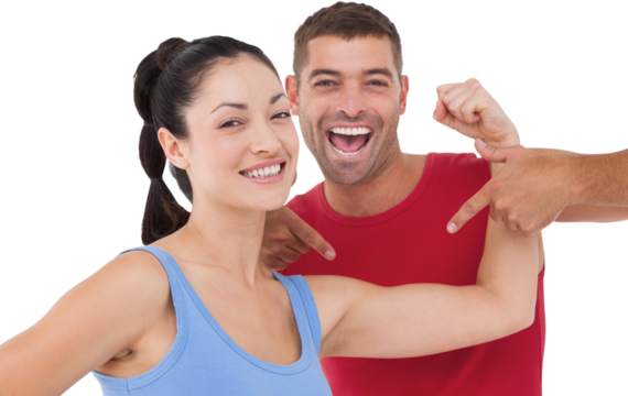 Fit woman and trainer smiling at camera