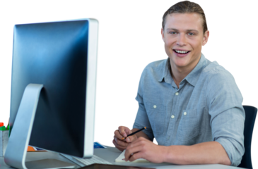 Portrait of businessman using computer at desk against white background