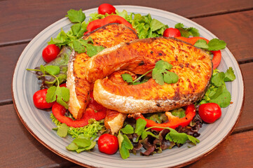 Salmon steak with vegetables in a plate