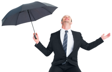 Businessman sheltering under black umbrella testing