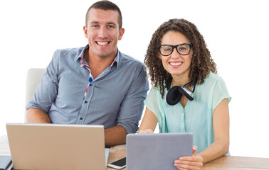 Portrait of creative business people with technologies at desk