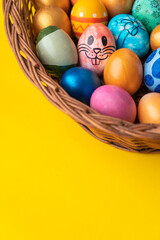 Fototapeta na wymiar Colourful easter eggs on the basket with copy space for greeting text, 2023 creative easter background