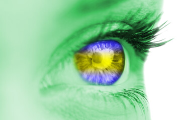 Blue and yellow eye on green face 
