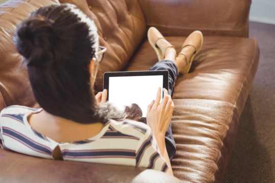 Businesswoman lying on sofa 
