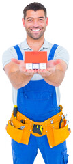 Portrait of happy construction worker holding house model