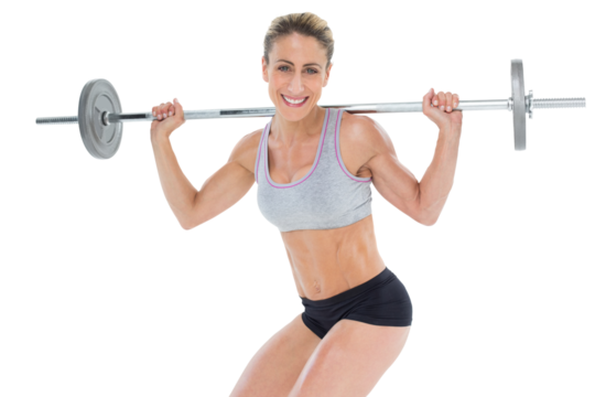 Smiling female crossfitter lifting barbell behind head looking at camera - Powered by Adobe