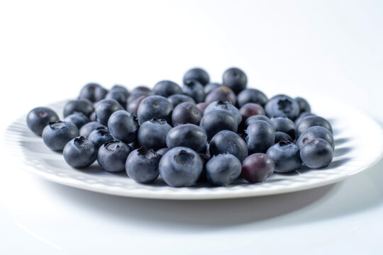 Closeup of fresh juicy blueberries on white plate isolated on white background, copy space. High resolution. Generative AI