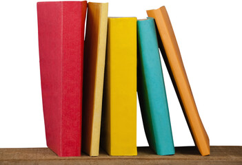 Colorful books arranged on wooden table