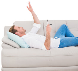 Man lying on sofa with hand raised 