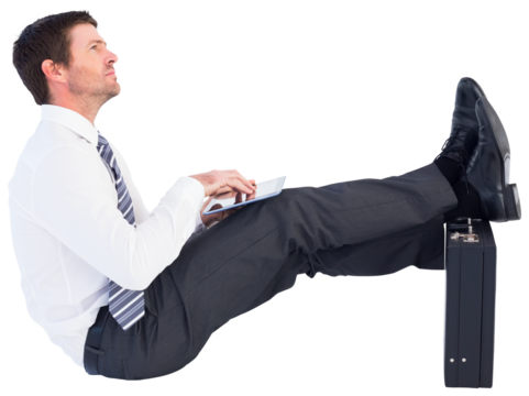 Businessman with feet up on briefcase