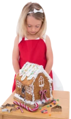 Schilderijen op glas Festive little girl making gingerbread house © vectorfusionart