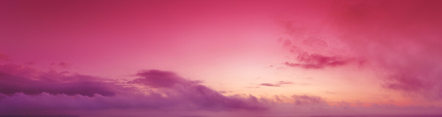 Cloudy sky at sunset. Magenta gradient color. Sky texture. Abstract nature background. Horizontal banner