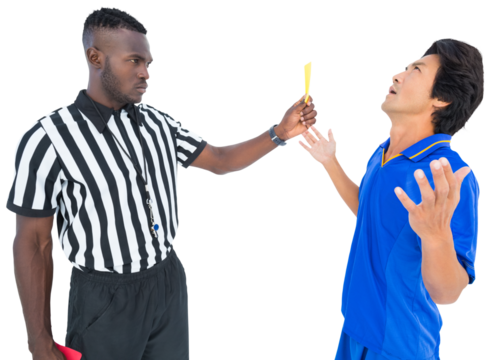 Stern referee showing yellow card to a player