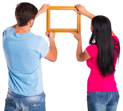 Young couple hanging a frame