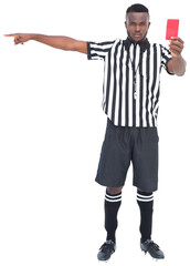 Stern referee gesturing while showing red card