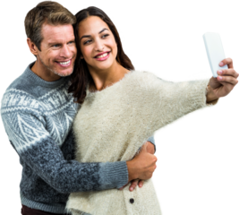 Happy couple wearing warm clothing taking selfie