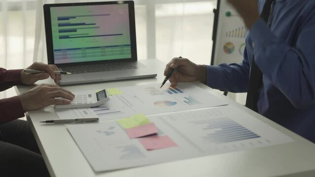 Businessmen summarizing their work in the company during the year new project in the office Young entrepreneurs brainstorm to analyze and plan business strategies.