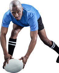 Portrait of sportsman bending and holding ball while playing rugby