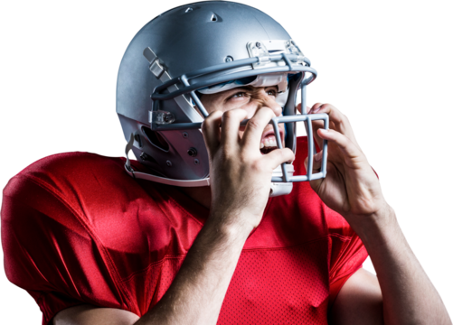 Aggressive American football player holding helmet