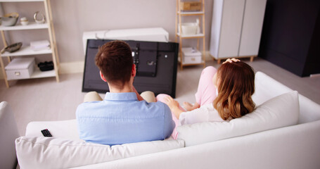 Man Sitting On Sofa In Front Fallen Television