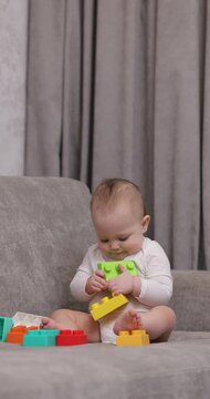 cute baby girl playing with colorful toy blocks