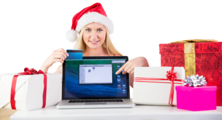 Festive blonde shopping online with laptop