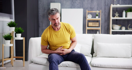 Man Suffering From Stomach Ache Sitting