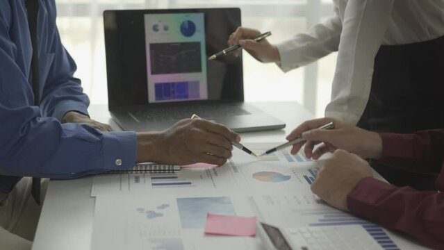 Businessmen summarizing their work in the company during the year new project in the office Young entrepreneurs brainstorm to analyze and plan business strategies.