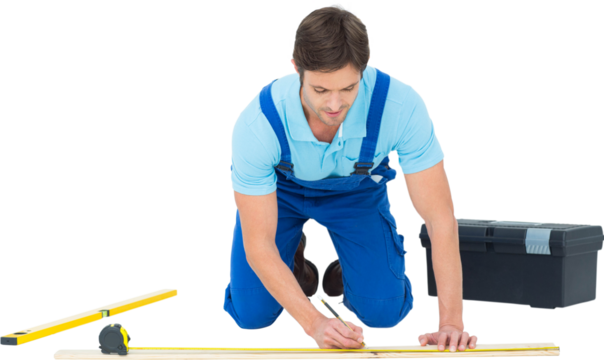 Worker marking on wood while measuring