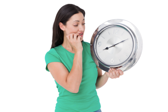 Brunette looking at wall clock - Powered by Adobe