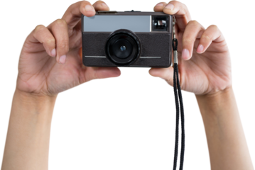Cropped hands holding camera