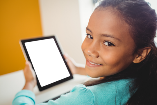 Girl smiling and holding digital computer