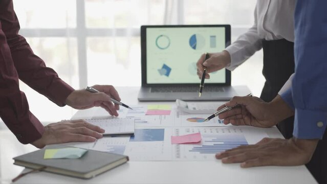 Businessmen summarizing their work in the company during the year new project in the office Young entrepreneurs brainstorm to analyze and plan business strategies.