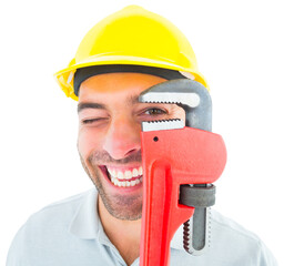 Naklejka premium Cheerful handyman looking through monkey wrench