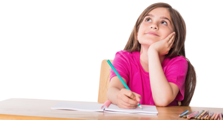 Cute pupil working at her desk