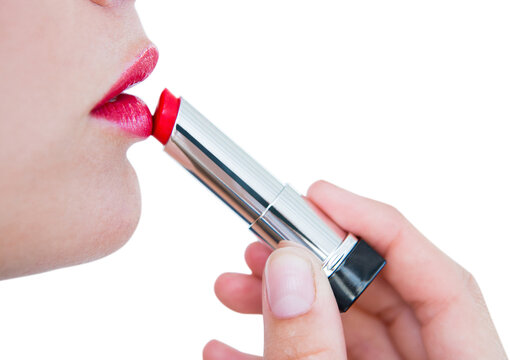 Fototapeta Woman putting red lipstick 