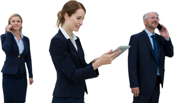 Businesswoman using tablet while colleagues talking on phone - Powered by Adobe