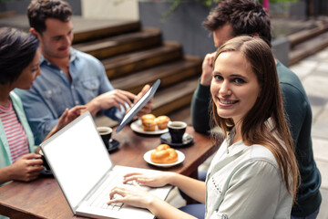 Young woman sitting with colleagues 