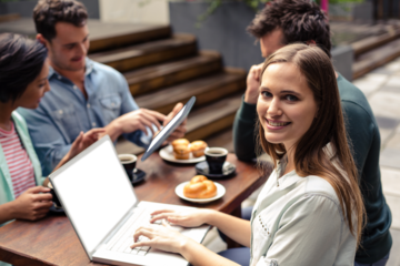 Young woman sitting with colleagues