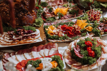 Snacks at the wedding, cheese, sausage, vegetables, meat products, Cossack table at the Ukrainian wedding.